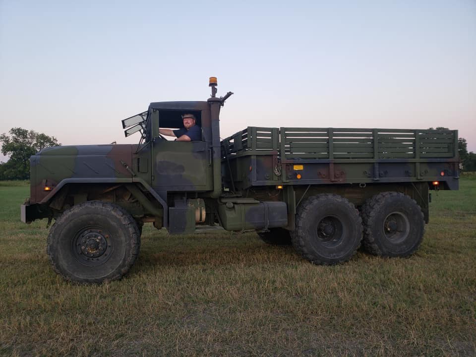 Image of military flatbed truck in field